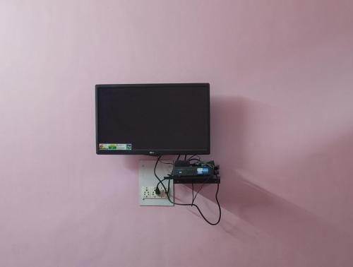 a flat screen tv hanging on a wall at Reet Preet Homestay in Jari