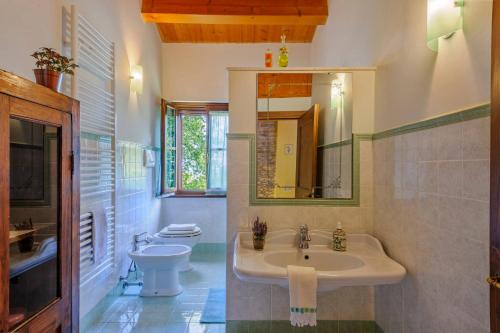 a bathroom with a sink and a toilet at Casale Partemio 8 by Marche Holiday Villas in Cartoceto