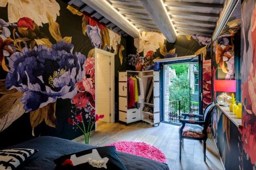 a bedroom with a flower mural on the wall at Casalino Galassi 4&2 by Marche Holiday Villas in Sarnano