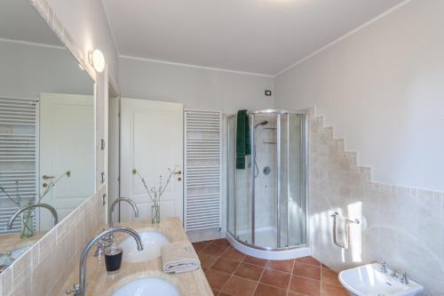 a bathroom with a shower and a sink and a tub at Villa Traiani 8&2 by Marche Holiday Villas in Piagge