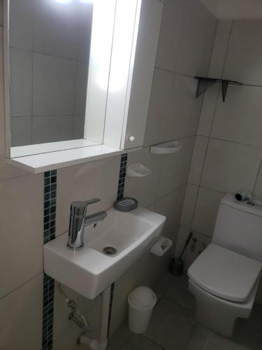 a bathroom with a sink and a mirror and a toilet at Shanti Loft in San Juan