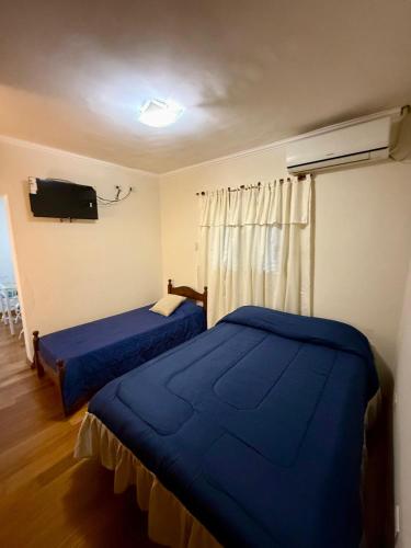 a bedroom with two beds and a tv on the wall at Shanti Loft in San Juan