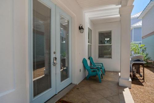 a porch with two blue chairs on a house at Home Sweet Destin - 6BDR - Sleeps 14 - Next 2 Beach in Destin