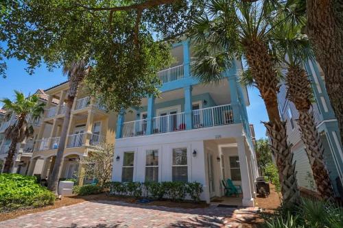 a blue and white house with palm trees in front at Home Sweet Destin - 6BDR - Sleeps 14 - Next 2 Beach in Destin