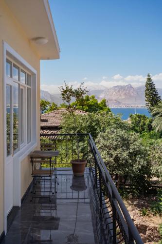a balcony of a house with a table and chairs at House of Good Things in Antalya