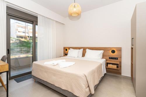 a bedroom with a large bed and a window at Dreta Suites in Chania Town