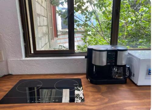 a coffee maker sitting on a counter next to a window at MI CASA EN TEPOZTLAn in Tepoztlán