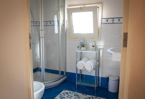 a bathroom with a shower and a sink at Historic building with pool in Gagliano del Capo