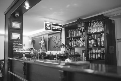 a bar with a lot of bottles of alcohol at Hotel & Restauracja Gniecki in Hrubieszów