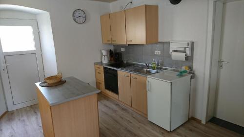 a small kitchen with a sink and a stove at Jurahaus Solnhofen in Solnhofen