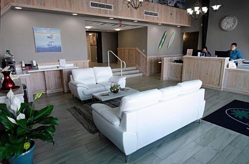 a lobby with white furniture and people at a salon at The Maverick in Ormond Beach