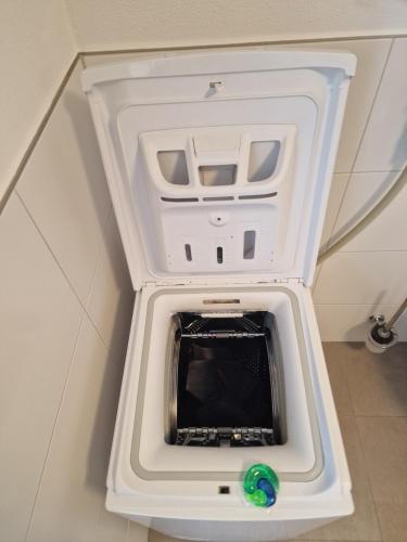a washer and dryer in a white cabinet at Stadt & See - neuwertige Ferienwohnung in Lindau