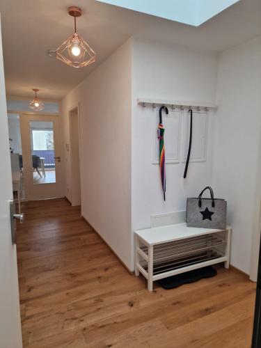 a room with a white wall with umbrellas on the wall at Stadt & See - neuwertige Ferienwohnung in Lindau
