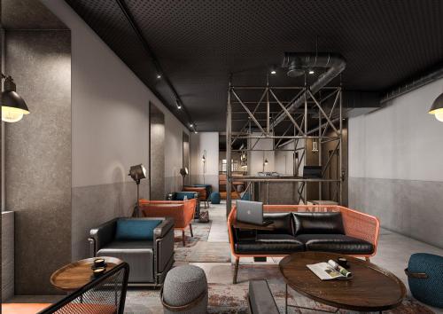 a lobby with couches and chairs and tables at Inspira Santos Boutique Hotel in Lisbon