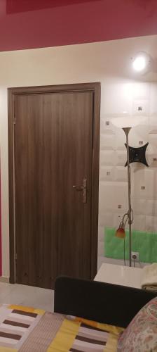 a door in a room with a bed and a lamp at Gościnne Gniazdo in Będzin