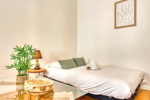 une chambre avec un lit et une table en verre dans l'établissement Le Martini - Clim mobile - studio au Brotteaux Métro B, à Lyon