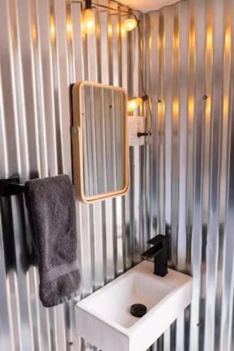 a bathroom with a sink and a mirror on the wall at Glamping Queen Tent At Private Riverside Ranch in Moab