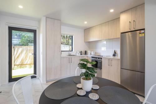 a kitchen with a table with a potted plant at Ariki Shire A Wellington Fantasy in Lower Hutt