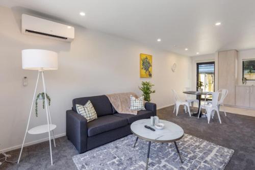 a living room with a couch and a table at Ariki Shire A Wellington Fantasy in Lower Hutt