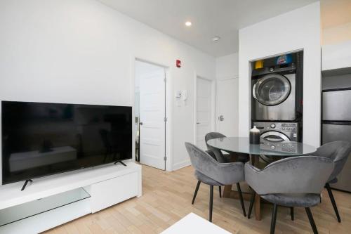 a living room with a tv and a table and chairs at Outstanding 1BR village downtown MTL in Montréal