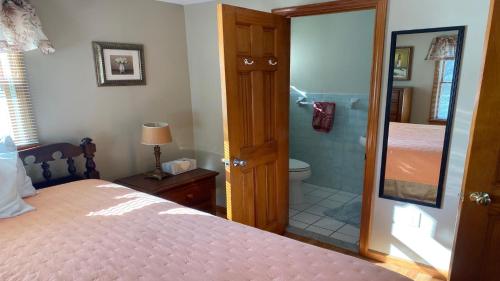 a bedroom with a bed and a bathroom with a shower at Brant Beach Condo Oceanside 3 Bed-2 Full Bath Seven Off The Beach, Sleeps 10 One Queen Master Two Double Beds In Bedroom Two And Two Singles In, in Brant Beach
