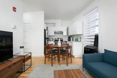 a living room with a table and a blue couch at Peaceful 2BR Getaway in Downtown in Montréal