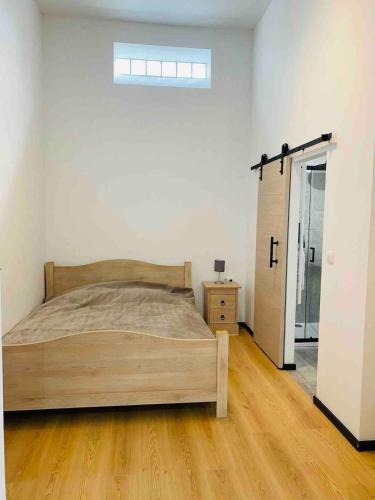 a bedroom with a bed and a door to a closet at Studio calme et lumineux à Uccle in Brussels