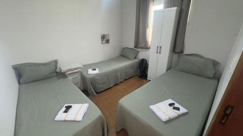 a room with two beds and a small room with at Casa Recanto da Paz in Uberlândia