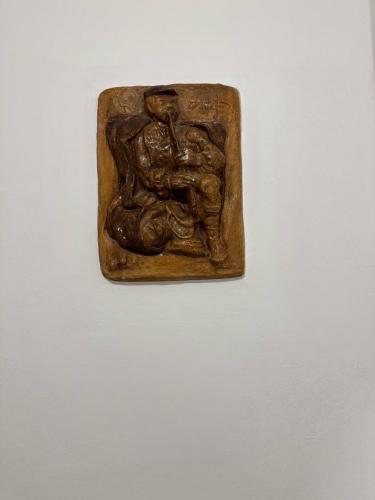 a bronze plaque of a person on a wall at Hanedan Hotel in Istanbul