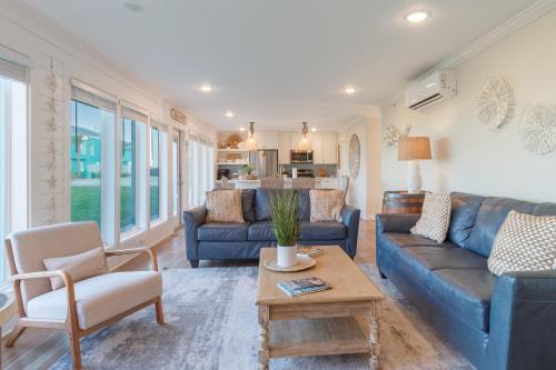 a living room with blue couches and a table at Executive Keys Condominiums on the Beach in Port Aransas