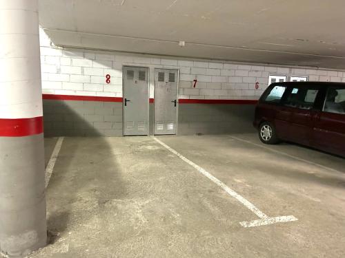 a parking garage with a van parked in it at Apartament amb una terrassa única by RURAL D'ANEU in Esterri d'Àneu