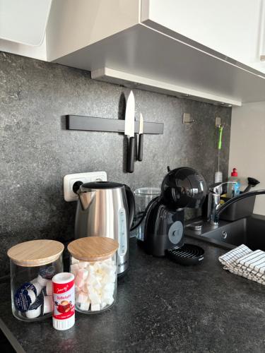 a kitchen counter top with a coffee pot and food at Modernes Serviced Apartment - FeWo Penthouse View in Nördlingen