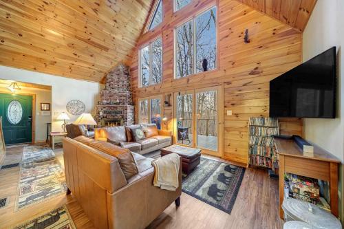 a living room with a couch and a flat screen tv at Hot Tub Fireplace Fire Pit Game Room & More in Morton Grove