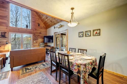 a dining room and living room with a table and chairs at Hot Tub Fireplace Fire Pit Game Room & More in Morton Grove