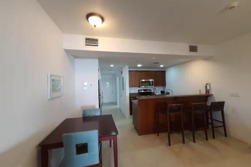a kitchen with a table and chairs in a room at Beautiful Apartament in Providenciales, Turks and Caicos Islands in Turtle Cove