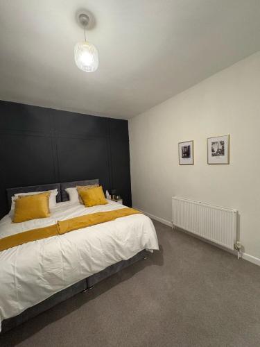 a bedroom with a large bed with a black headboard at 2 Bedroom House for Contractors in Oswaldtwistle