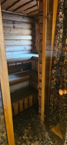 a small room with a bench in a wooden house at NPLIHOUSE in Otepää