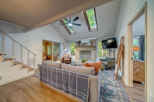 a living room with a couch and a ceiling fan at Secluded Retreat w Hot Tub, FirePit & Pool Access in Hedgesville