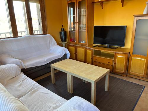a living room with a couch and a tv at CASA MENCIA in Sober