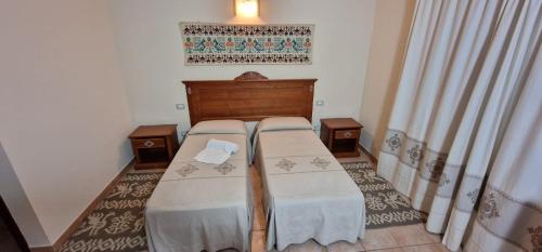 Ένα ή περισσότερα κρεβάτια σε δωμάτιο στο Albergo Ristorante Pizzeria Monte Arcosu