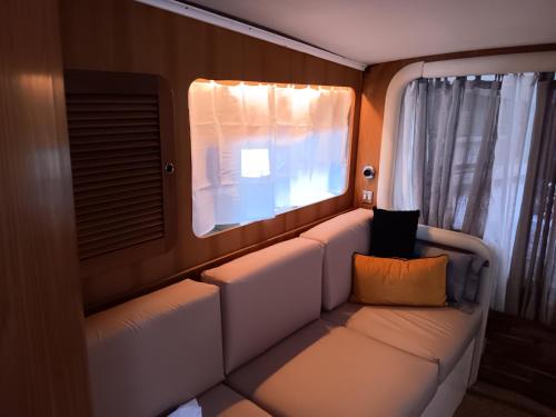 an empty seat in an airplane with a window at Bateau au bassin des lumières in Bordeaux