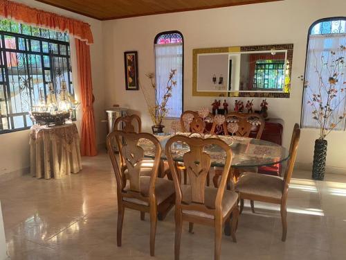 a dining room with a table and chairs at villa bonita in Florencia