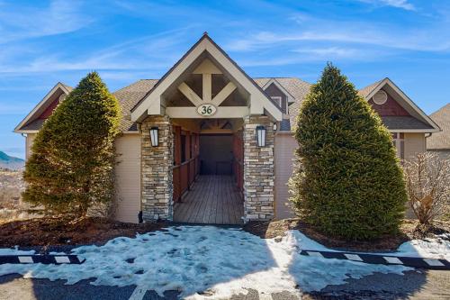 a house with a clock on the front of it at Reserve 36-D in Sugar Mountain