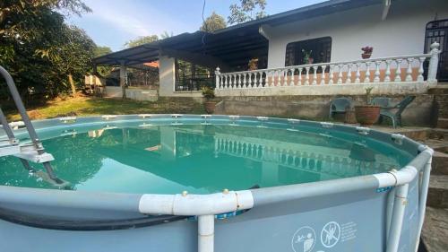 a swimming pool in front of a house at villa bonita in Florencia