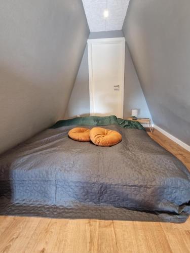 two pillows sitting on a bed in a attic at Stædets lejlighed in Bøvlingbjerg