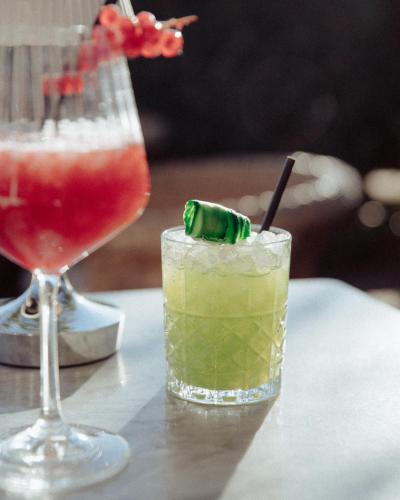 two cocktails sitting on a table with a drink at Hôtel de la Plage - Ronce-les-bains in Ronce-les-Bains