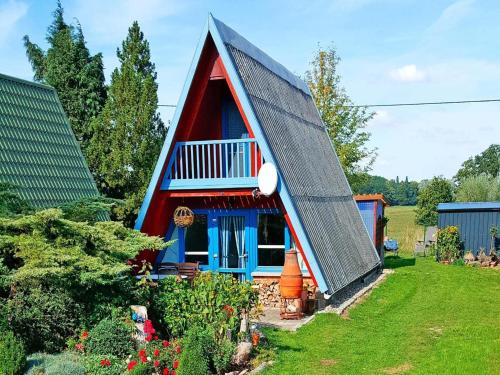 a red and blue house with a gambrel roof at Ferienhaus, Perlin in Perlin