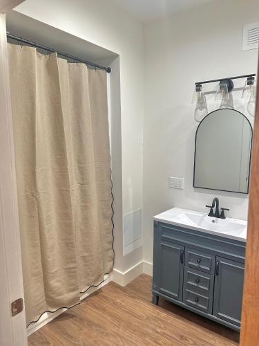 a bathroom with a sink and a mirror at Hidden Gem of the Westside in Providence