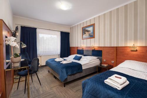 Postel nebo postele na pokoji v ubytování Hotel Rejs