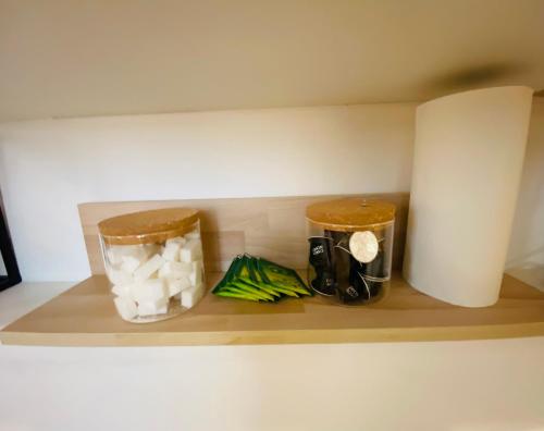 a kitchen shelf with food items on it at Le Cocon, studio tout confort, hypercentre in Poitiers